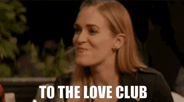 a woman says " to the love club " in front of her