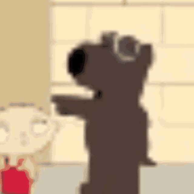 a blurry picture of a cartoon character standing next to a cartoon character .