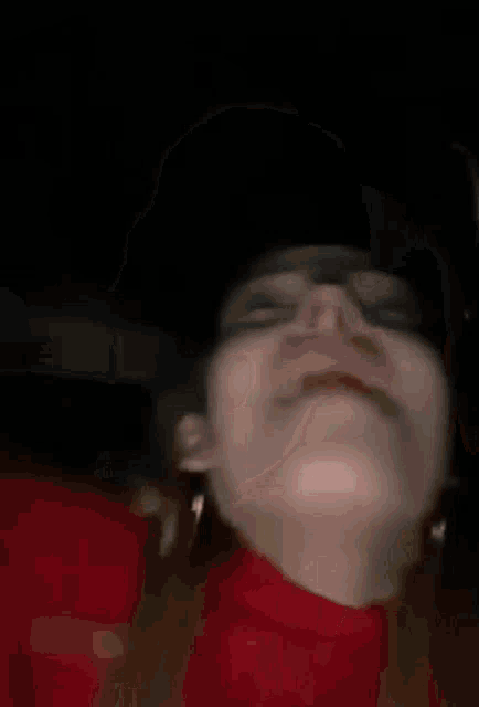 a close up of a person 's face with their eyes closed and their mouth open .