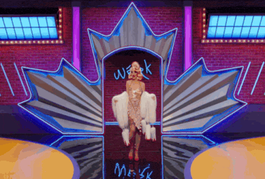 a woman stands in front of a canadian maple leaf with the word weak written on it