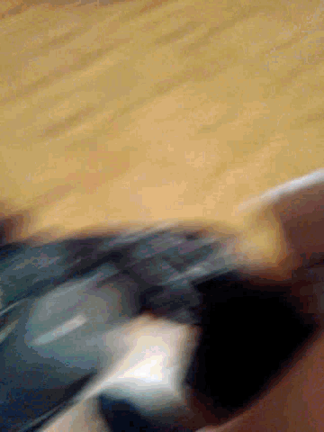 a blurry picture of a person 's face with a blurred background of a wooden surface