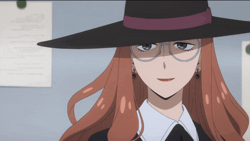 a woman wearing glasses and a hat is smiling