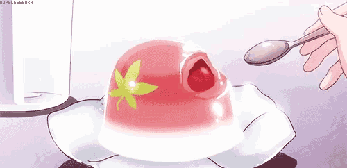 a person is holding a spoon over a strawberry jelly dessert on a plate .