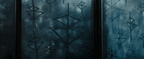 a dark window with a pattern of triangles and crosses on it