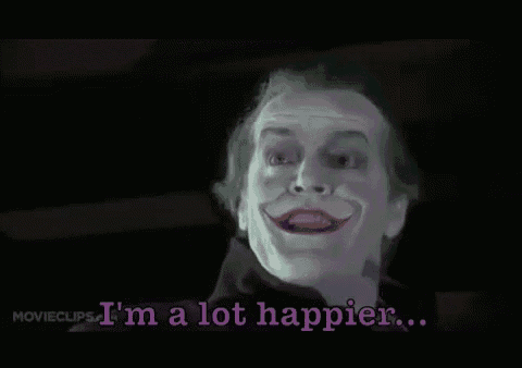 the joker is smiling and saying i 'm a lot happier ..
