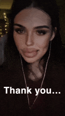 a woman wearing earphones says thank you