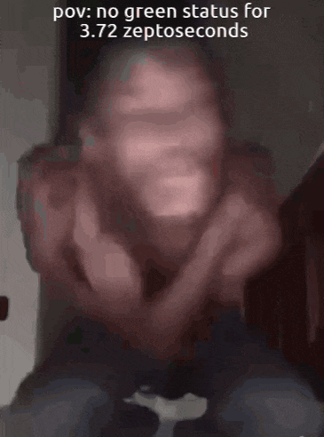 a man is making a funny face while sitting down with his hands in his pockets .