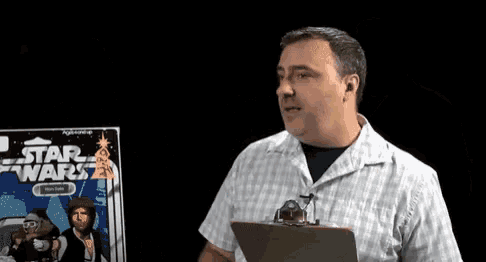 a man is holding a clipboard in front of a star wars book