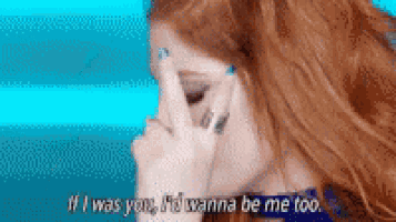 a woman is talking on a cell phone and covering her face with her hand .