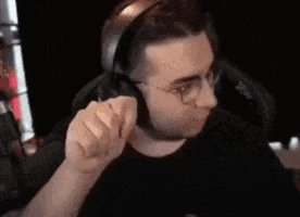 a man wearing headphones and glasses is making a funny face .