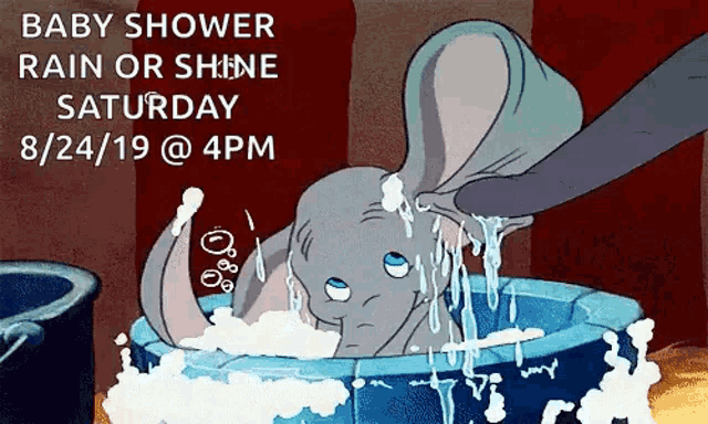 dumbo is taking a bath in a tub with soap bubbles .