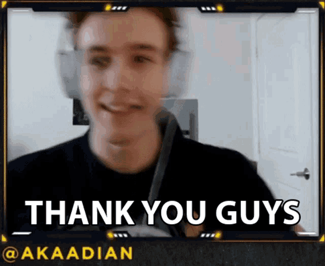 a man wearing headphones is smiling and saying thank you guys on a video call .