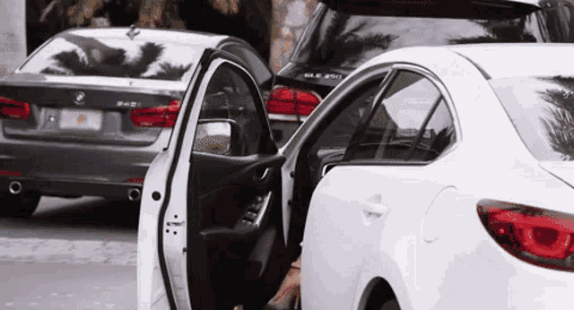 a woman getting out of a white car with a license plate that says florida