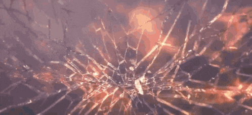 a person is standing in a dark room with a bunch of fire coming out of their head .