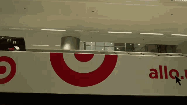 a white sign with a red target and the word alla
