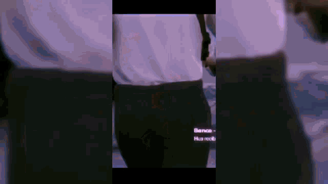 a man in a white shirt and black pants is walking down the street