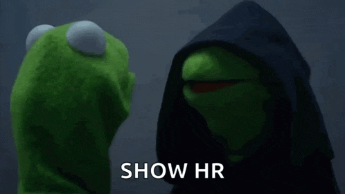 kermit the frog is standing next to a muppet wearing a black hooded jacket .
