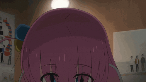 a girl with pink hair and blue eyes looks at a cell phone