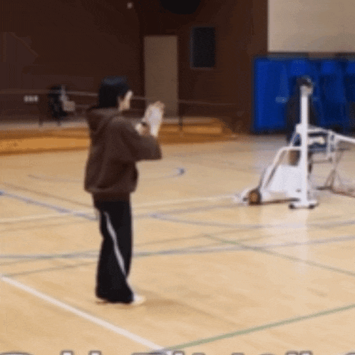 a person standing on a basketball court holding a basketball