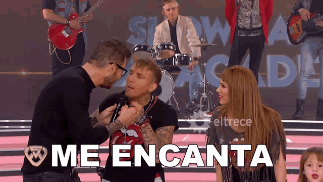 a group of people standing on a stage with the word me encanta in white letters