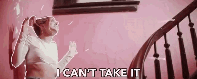 a woman is standing in front of a pink wall with the words i can 't take it
