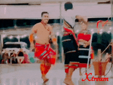 a man is dancing in front of a sign that says " xstream "
