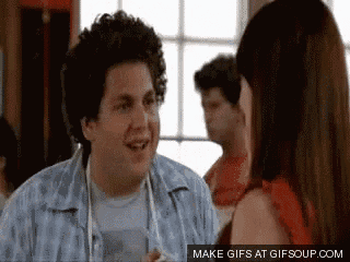 a man with curly hair is talking to a woman