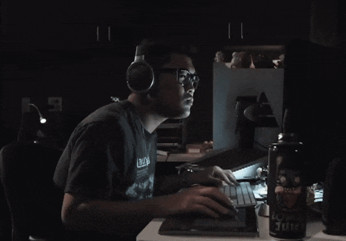 a can of lower juice sits on a desk next to a man