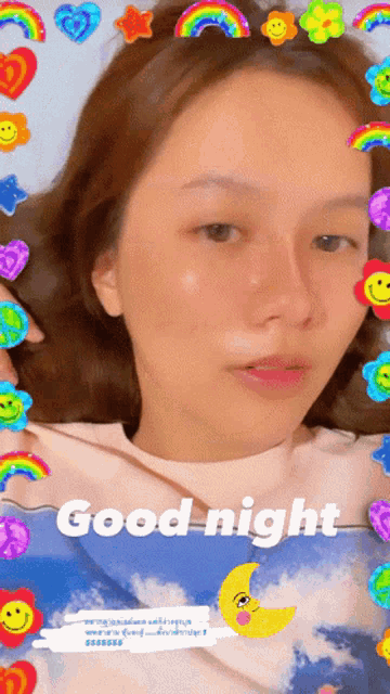 a woman is laying in bed with a good night sticker on her head