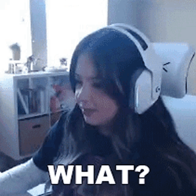 a woman wearing headphones is sitting in front of a computer and asking what ?