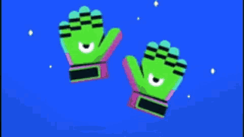 a pair of green gloves with eyes on them are flying in the air .