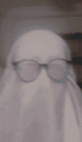 a blurry picture of a person wearing glasses and a ghost .