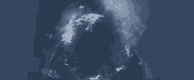 a dark blue background with a few white clouds