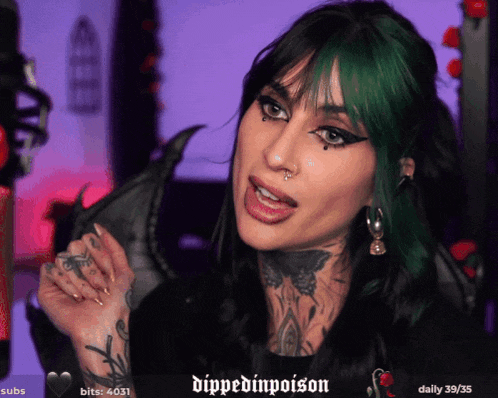 a woman with green hair is talking on a twitch channel