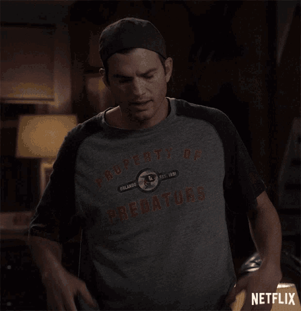 a man wearing a property of predators shirt