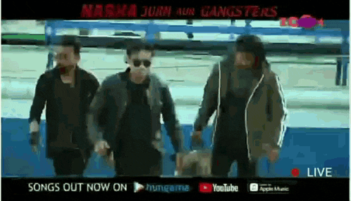 a group of men are walking in front of a sign that says songs out now on