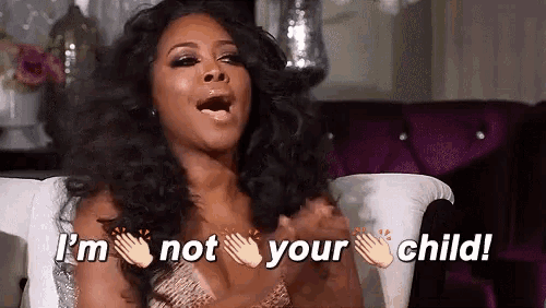a woman is sitting on a couch and saying `` i 'm not your child ! ''
