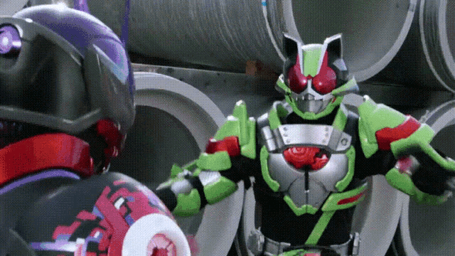 a green and black superhero is standing next to a purple superhero .