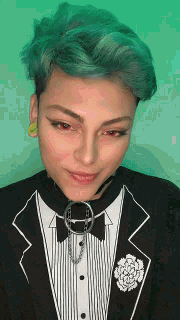 a woman with blue hair is wearing a tuxedo and collar