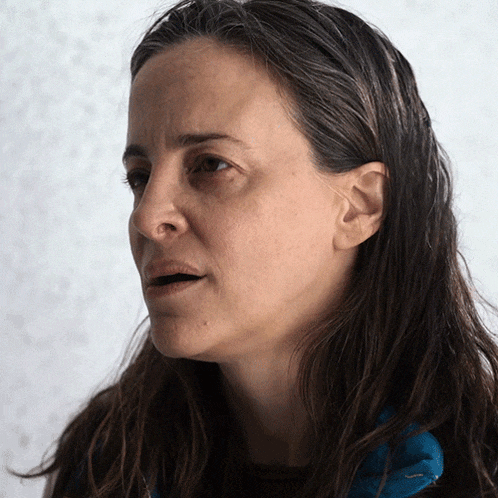 a close up of a woman 's face with a serious expression