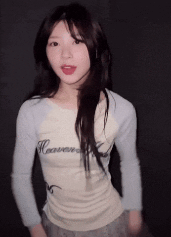 a woman wearing a shirt that says " heaven " on it