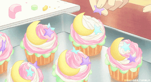 a bunch of cupcakes with moons and stars on top