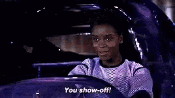 a woman is driving a purple car and saying `` you show off '' .