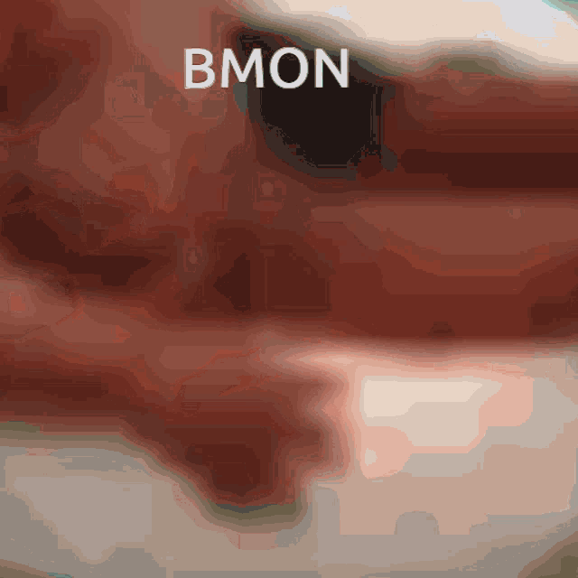 a blurry picture of a person 's face with the word bmon written on it