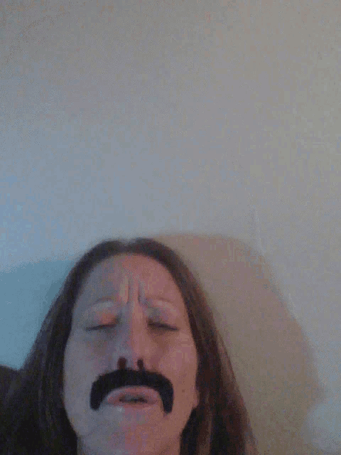 a woman with a fake mustache on her face smiles
