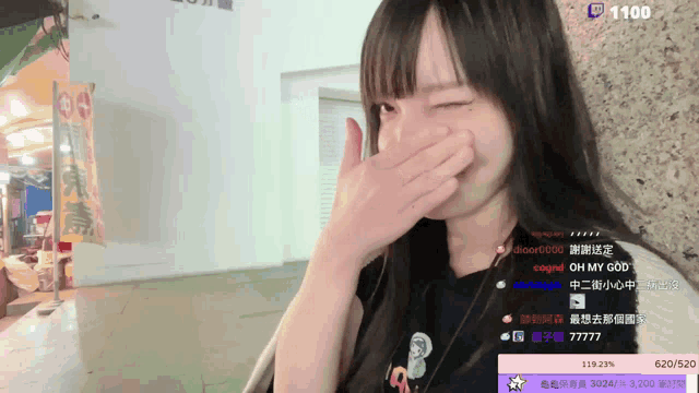 a girl covering her mouth with her hand in front of a banner that says ' oh my god '