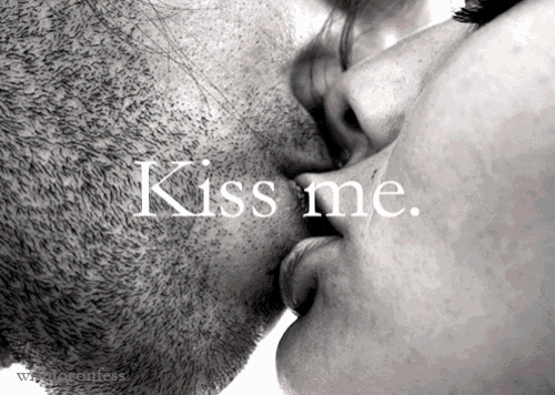 a black and white photo of a man and woman kissing with the words " kiss me " above them