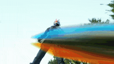 a person wearing a helmet with cat ears is standing in front of a blue and orange background