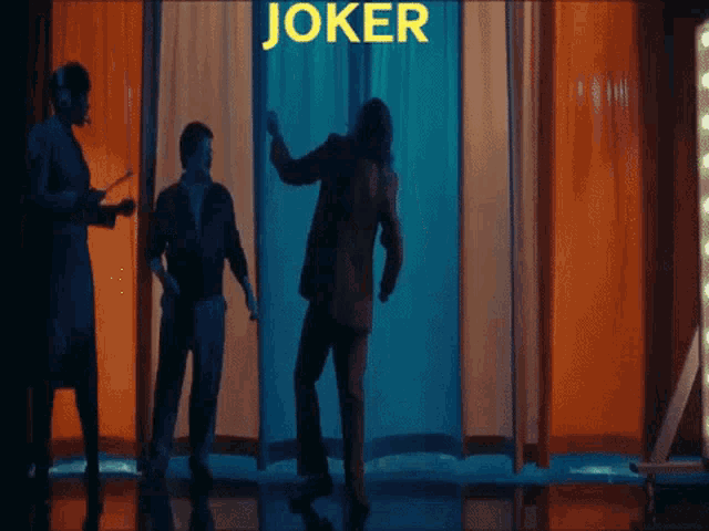 a man in a joker costume is dancing in front of a curtain