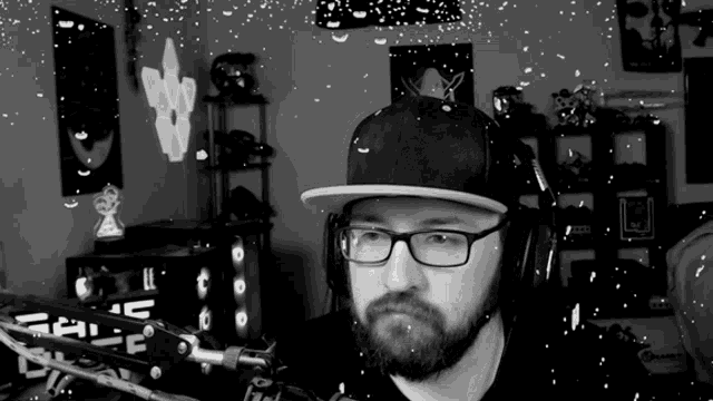 a black and white photo of a man wearing glasses